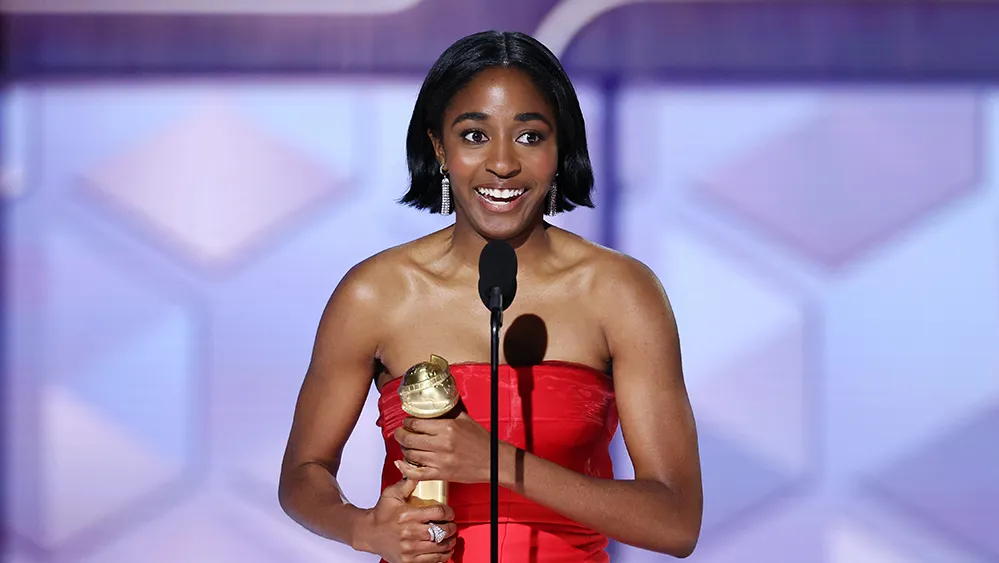 Ayo Edebiri receiving an award